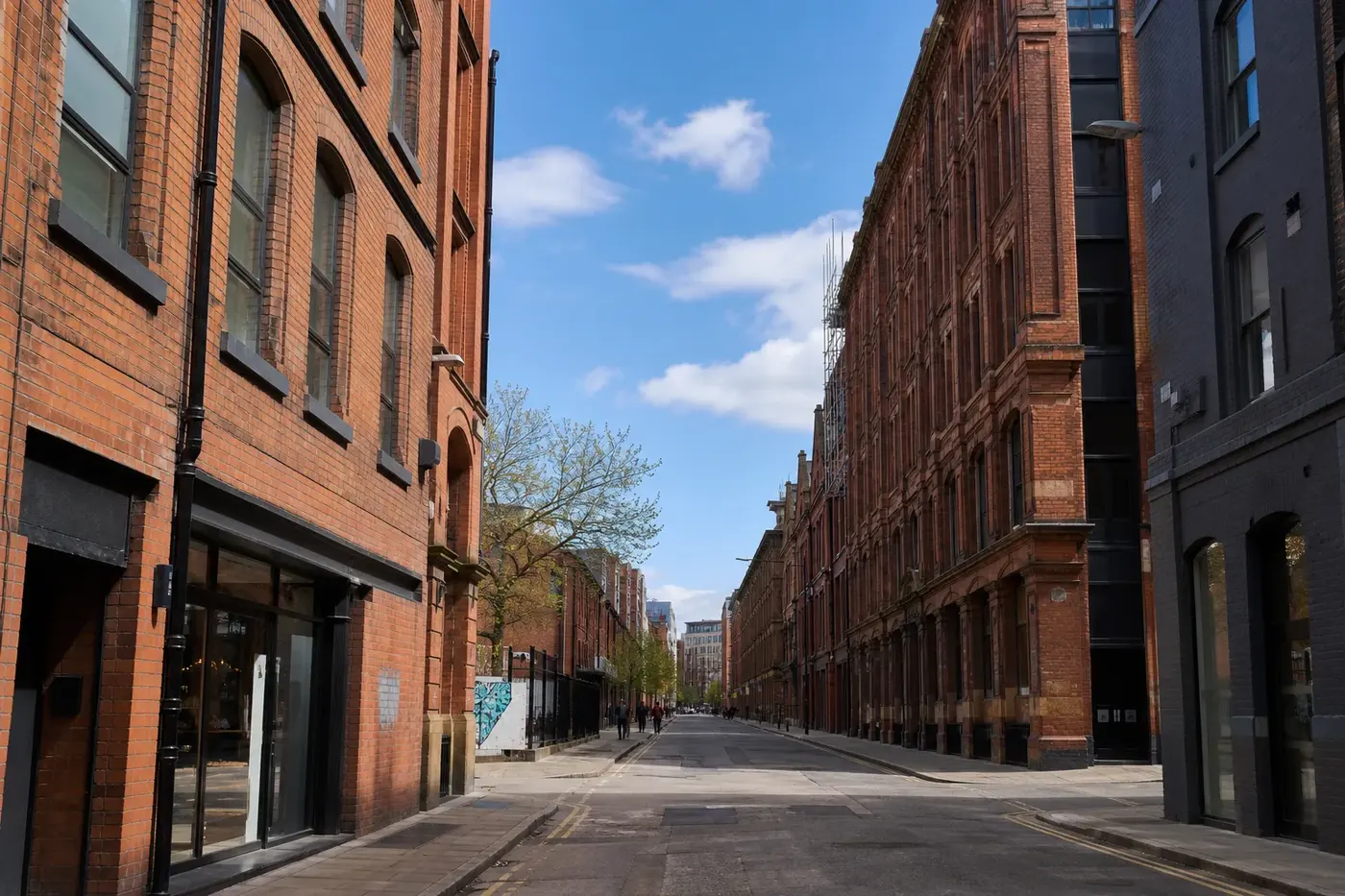 Red-brick Victorian warehouses on a street in Manchester’s Northern Quarter