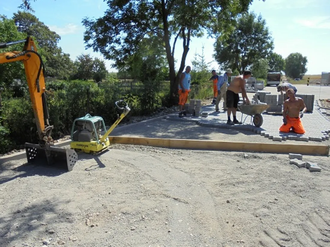 Operatives laying block paving