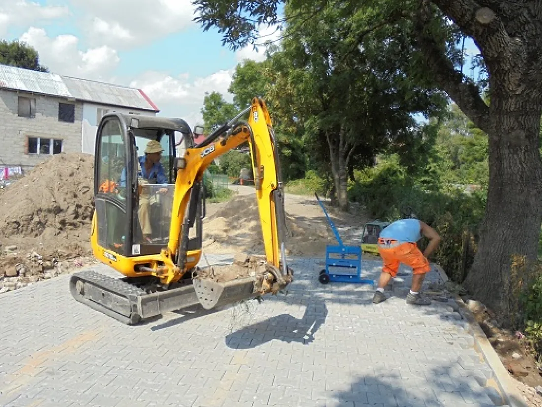 Mini digger and block paving on a municipal road build