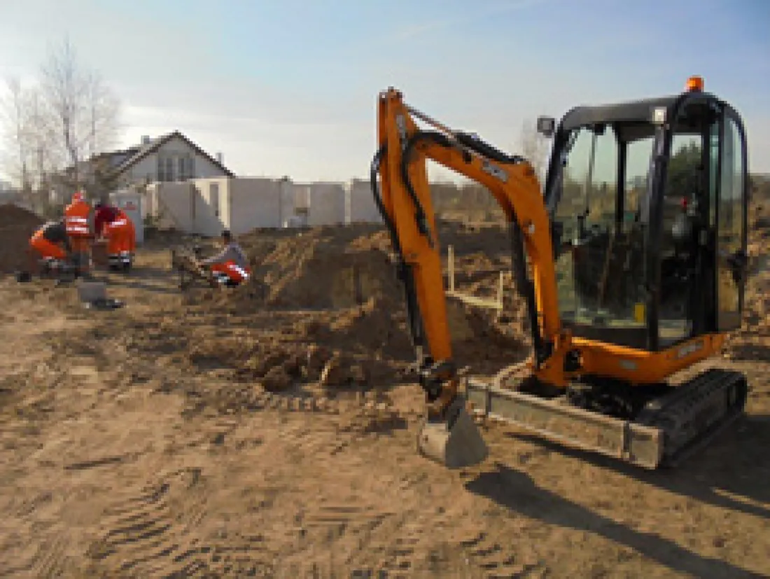 Mini digger at the foundations of a house