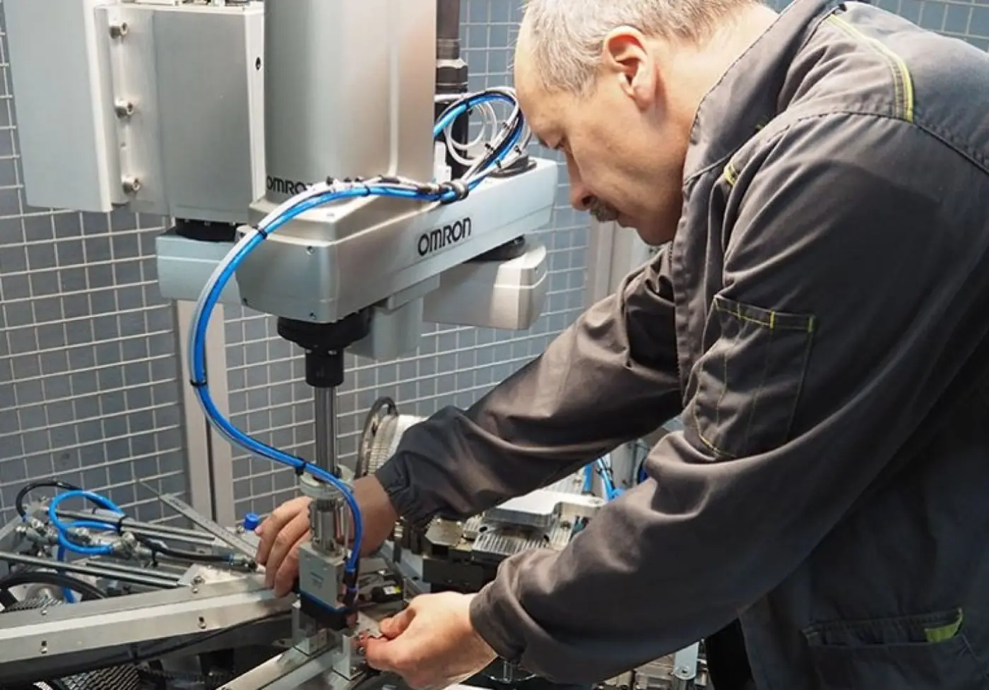 A Welmasz technician installing an industrial robot inside a machine