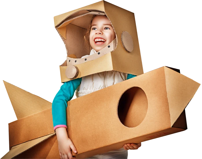Smiling girl in a cardboard helmet and rocket