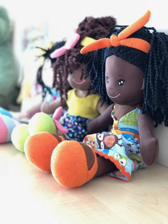 Rag dolls sitting on a shelf