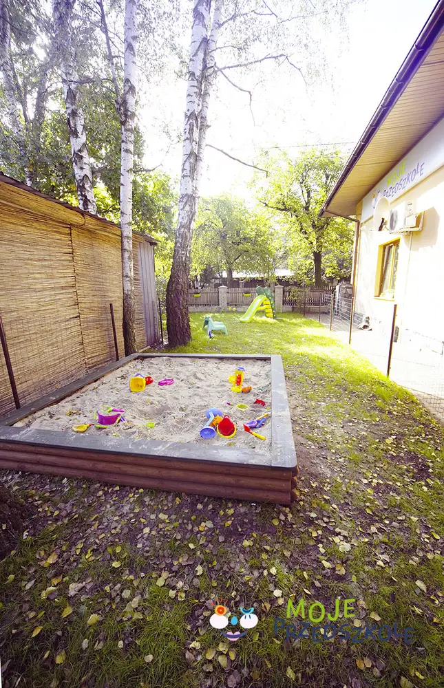Sandpit in the preschool garden, in the shade of the trees
